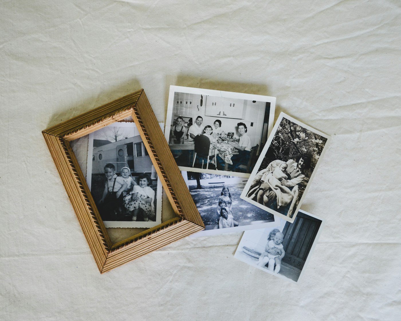Stare crno-bijele obiteljske fotografije uz drveni okvir